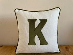 a pillow with the letter k on it