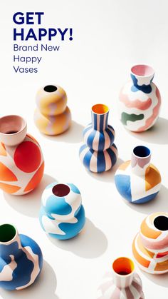 colorful vases are arranged on a white surface with the words, get happy brand new happy vases