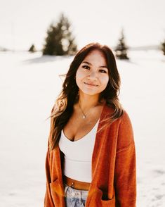 a woman standing in the snow smiling