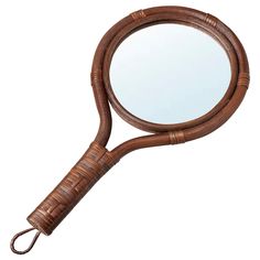 a round mirror sitting on top of a wooden handle