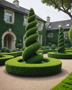 a large green garden with hedges and trees