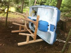 an ice chest in the woods with wooden slats