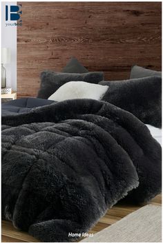 the bed is made with black fur and pillows