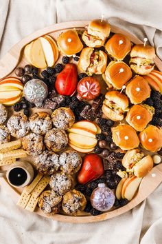 a platter filled with lots of different types of food on top of a table