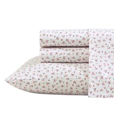 the sheet set is white with pink flowers on it and has two pillow cases in front