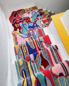 the colorful rugs are lined up on the stairs