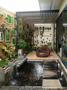 an outdoor living area with water and plants