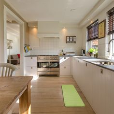 a kitchen with wooden floors and white cabinets