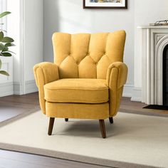 a yellow chair sitting on top of a rug next to a fire place in a living room