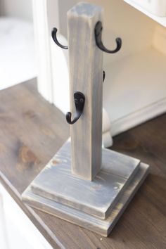 a wooden stand with two black handles on it