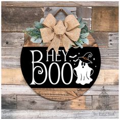 a wooden sign that says hey boo on it with a bow hanging from the front