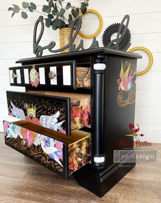 an artisticly decorated desk with drawers and decorative items on it's top shelf