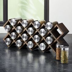 an assortment of metal items on a counter next to a canister with spices in it