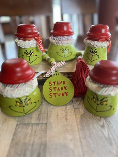 the grin face jars are decorated with red and green yarn