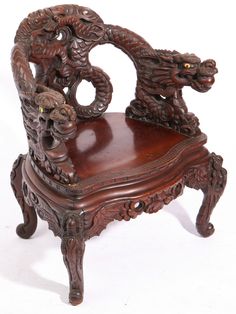 an ornate wooden chair with carved carvings on the back