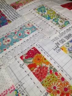 a close up view of a quilt with many different designs on it and the ruler