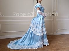 1870s Tournure Dress in luxurious satin and lace. Luxury 100% polyester satin. Price includes: The bustier with lacing in the back The skirt The crinoline cage for the bouffant in the back. Give us: Your chest measurement, waist measurement, and your total height from the top of your head to the floor. Dress made to order in approximately 6 weeks. Available sizes: XXS, XS, S, M, L, XL Beautiful dress with a very nice effect! Careful packaging. Blue 1870s Dress, Satin Victorian Dress, Crinoline Cage, 1870s Dress, Victorian Gown, Fancy Clothes, Lace Ball Gowns, Waist Measurement, Fashion Board