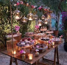 a table topped with lots of cakes and desserts