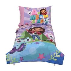 a child's bed with an image of dora the mermaid on it and other items