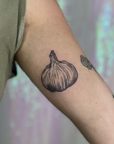 an onion tattoo on the left arm