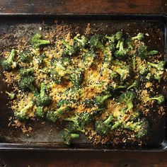 broccoli florets on a baking sheet with seasoning sprinkles