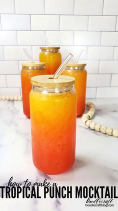 three jars filled with liquid sitting on top of a white marble counter next to a phone