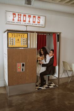 a man and woman are sitting in a booth