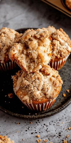 some muffins are sitting on a black plate