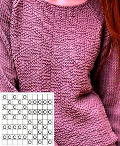 a woman with red hair is wearing a purple sweater and has her hands on her hips