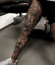 a man's leg with tattoos on it