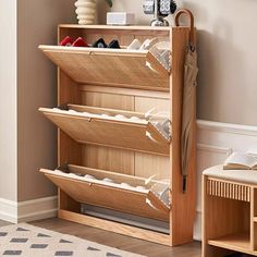 a wooden shoe rack with several pairs of shoes on it in front of a beige wall