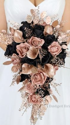 a bridal bouquet with black, pink and gold flowers in the bride's hand