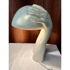 a sculpture of a hand on top of a table