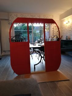 an open door to a dining room with tables and chairs in the middle of it