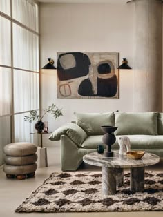 a living room filled with lots of furniture and decor on top of a white rug