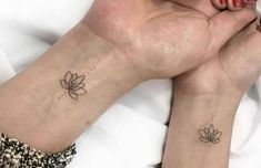 two small lotus tattoos on both wrist