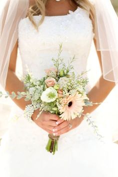 a woman in a wedding dress holding a bouquet