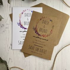 two wedding save the dates cards on top of each other