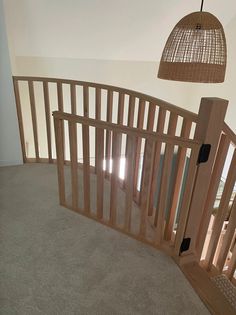 an empty room with wooden railings and a light fixture