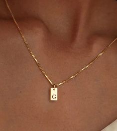 This personalized necklace features a sleek 14k gold rectangular pendant engraved with an elegant initial of your choice. Suspended from a delicate yet durable chain, this timeless piece is perfect for everyday wear or as a thoughtful gift. Its minimalist design adds a touch of sophistication, making it a versatile accessory for any occasion. Dimensions: • Pendant: Approx. 1.5 cm x 0.8 cm (0.6 inches x 0.3 inches) • Chain Length: Adjustable, 45 cm - 50 cm (17.7 inches - 19.7 inches Key Features A Letter Necklace, Minimalist Gold Jewelry, Gold Letter Pendants, Letter Necklace Initials, Gold Minimalist Jewelry, Gold Initial Pendant, Minimalist Jewellery, Initial Necklaces, Best Dad Gifts