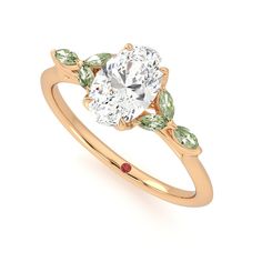 a yellow gold ring with three stones on the side and an oval cut diamond in the center