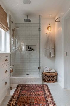 a bathroom with a rug, shower and sink