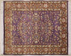 an antique rug with purple and gold colors