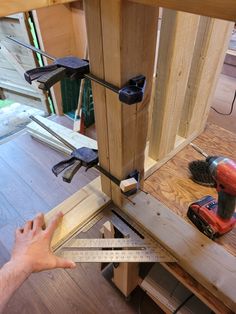 a man is measuring the height of a piece of wood