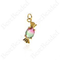 a gold plated charm with a pink and green stone