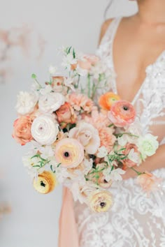 a woman holding a bouquet of flowers in her hands