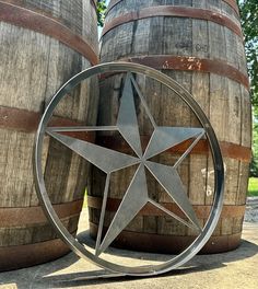 a metal star sitting on top of wooden barrels