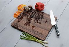 a cutting board with some vegetables on it and a knife sitting next to the cutting board