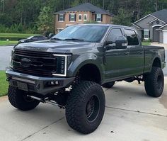 a large gray truck parked in front of a house