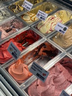 an assortment of ice creams in trays for sale